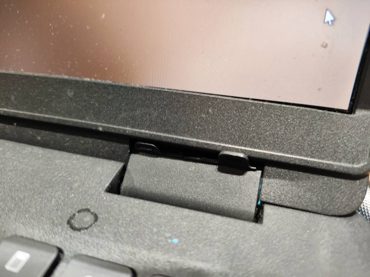 Laptop screen pulling away due to broken hinge before repair