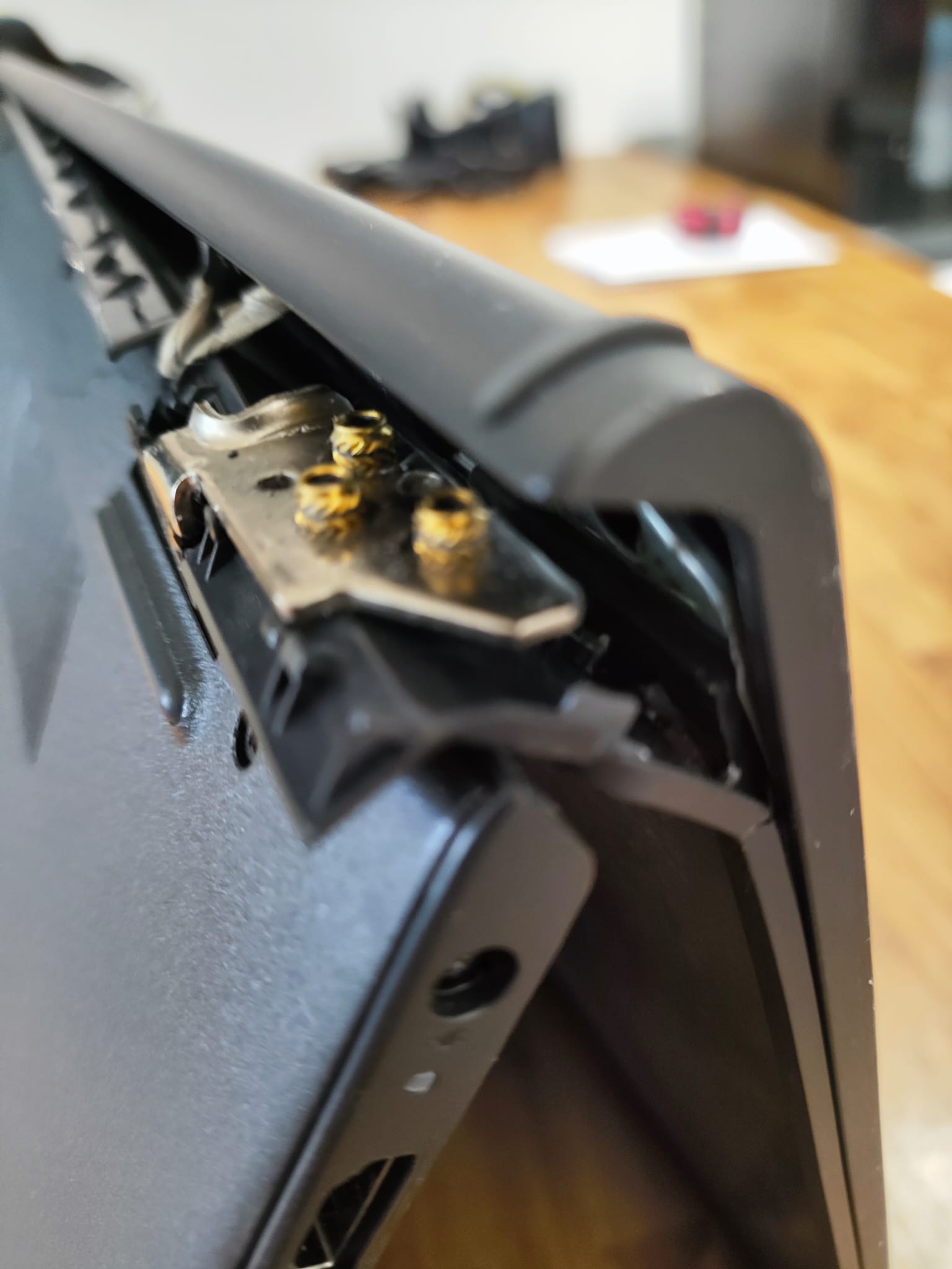 Exposed broken Dell laptop hinge and failed fixing points