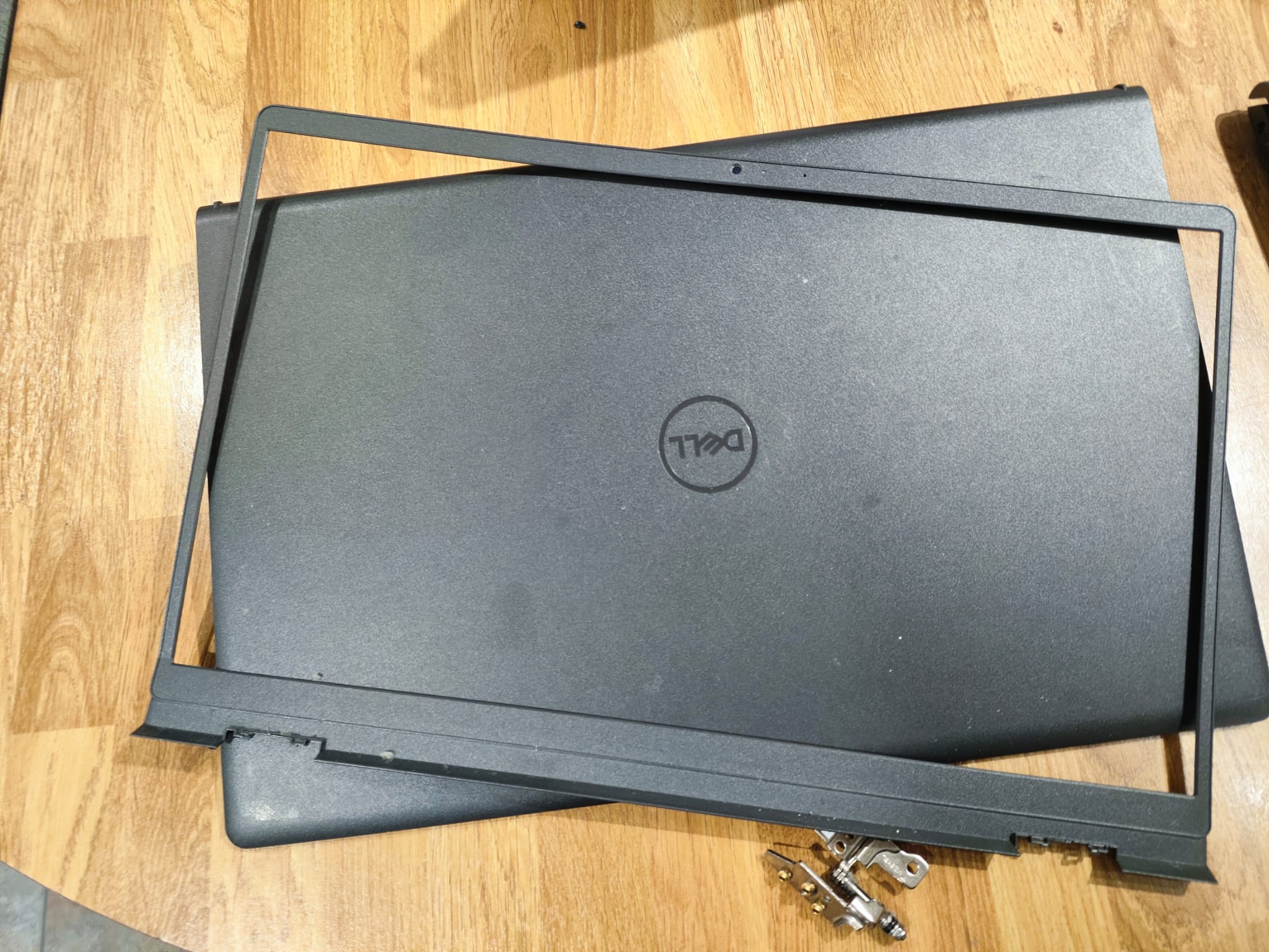 Broken Dell laptop screen bezel damaged by hinge failure